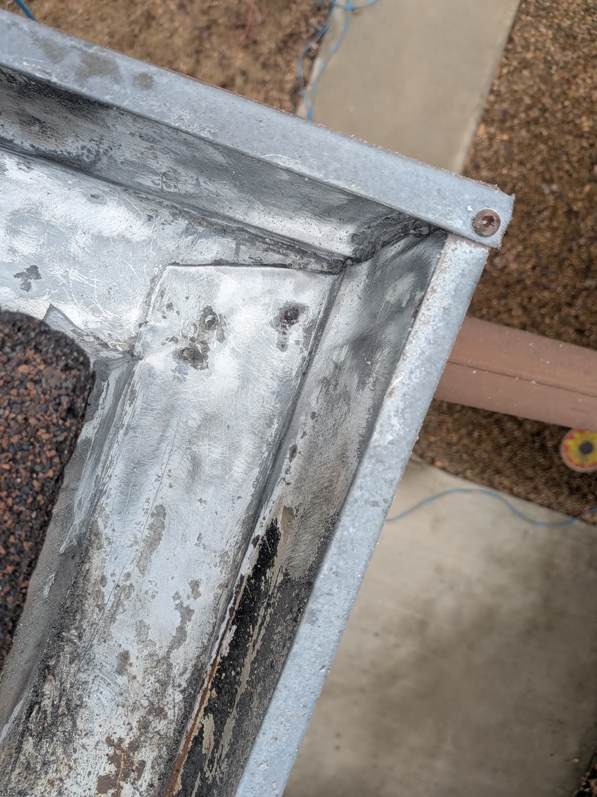 Sealant being applied to gutter corner joint