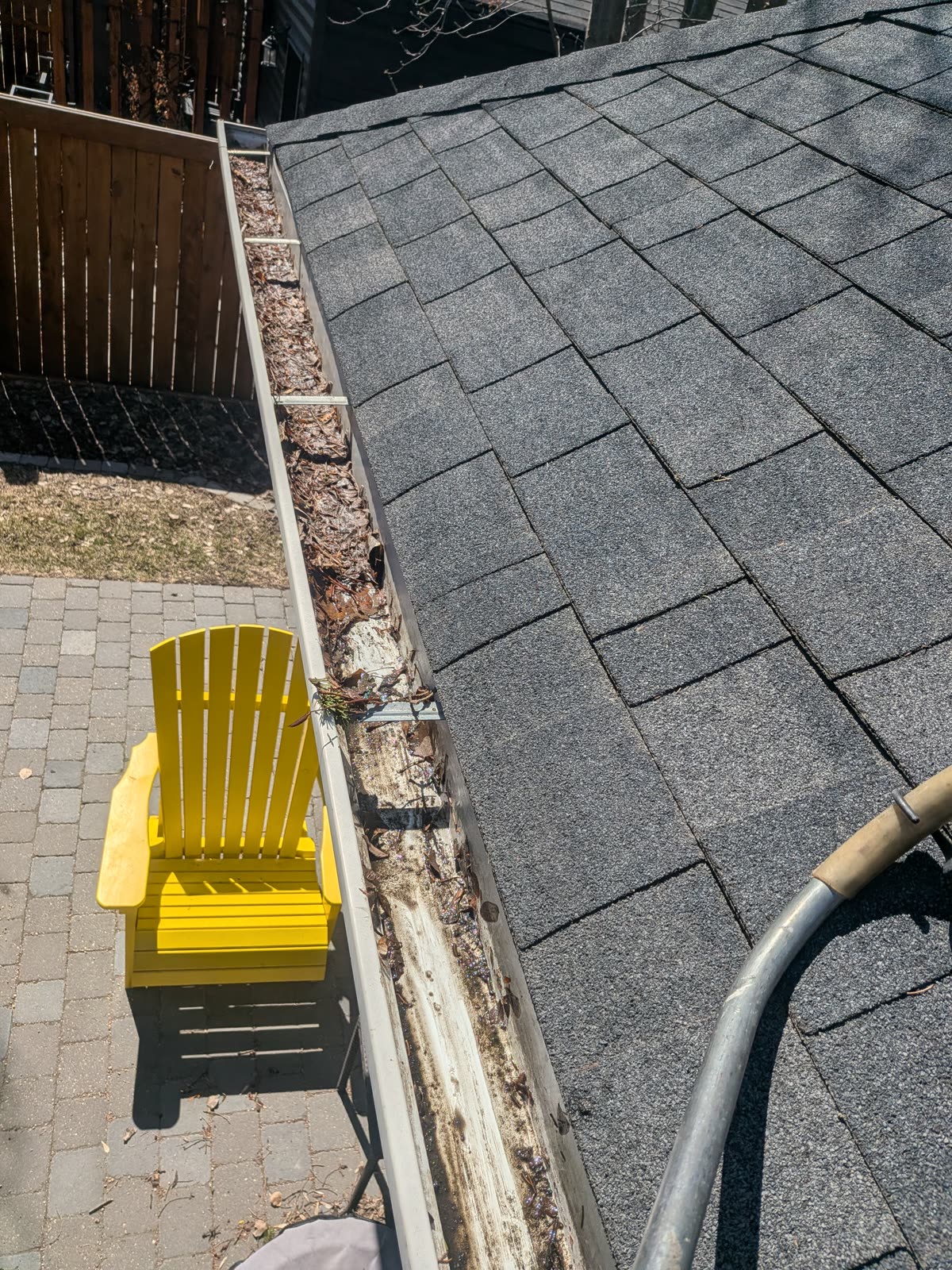 Clogged eavestrough with leaves and dirt