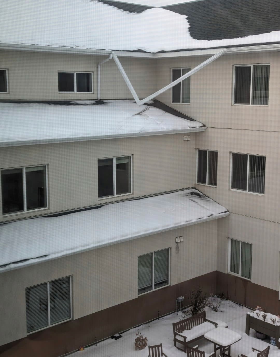 Gutter installation ladder setup on house exterior
