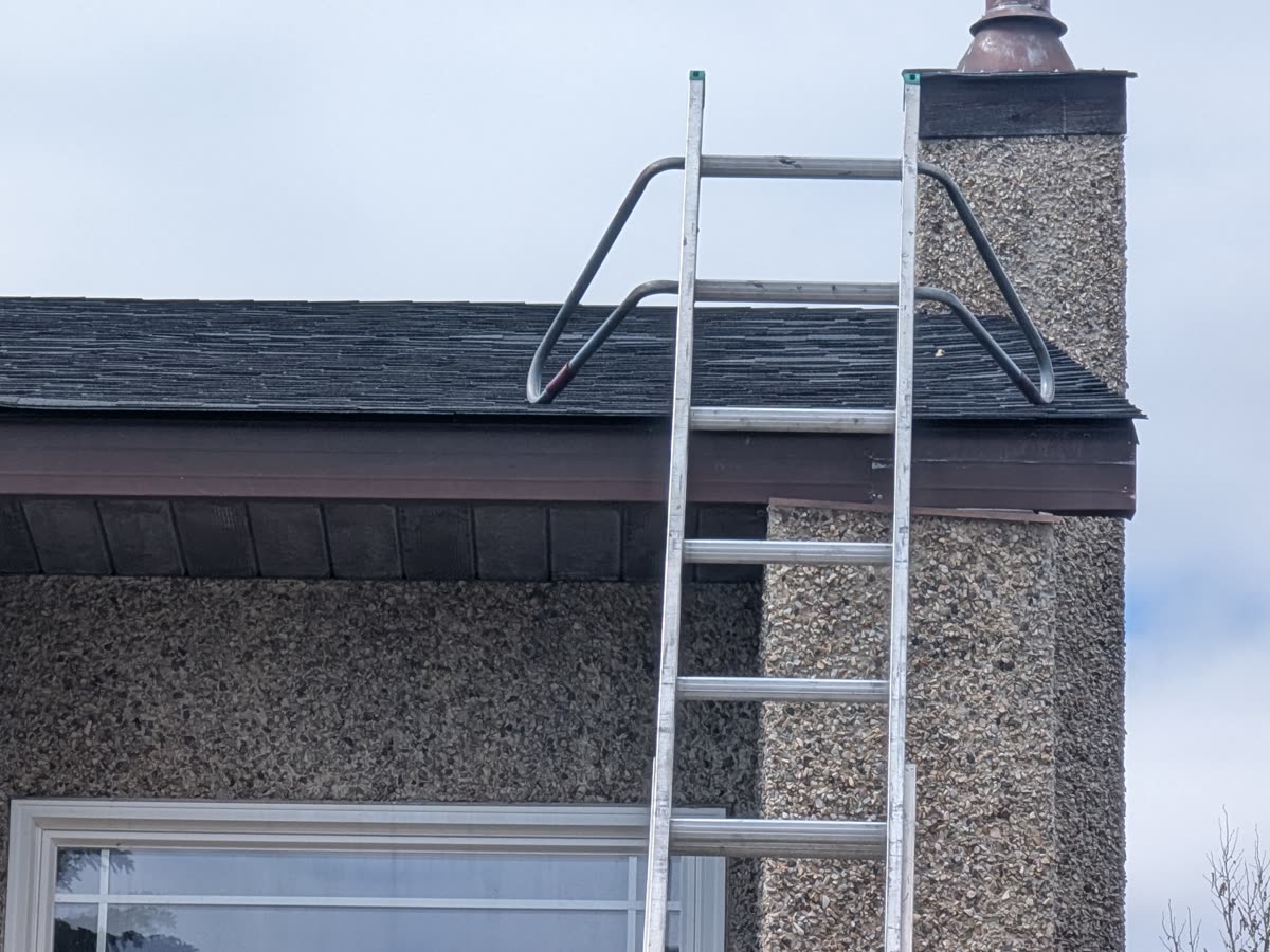 New eavestroughs being installed on fascia board