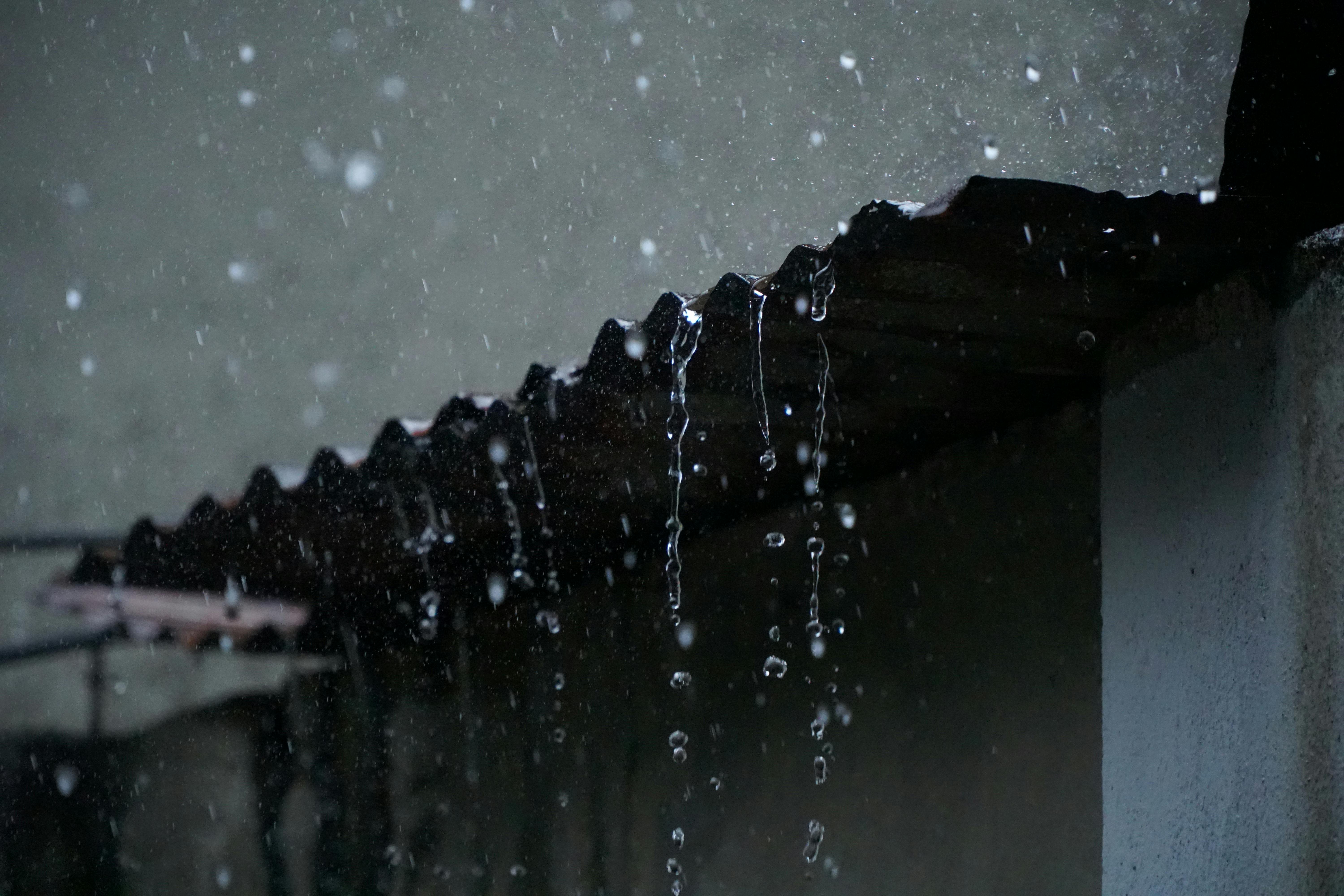 Rain moving along the edge of a roof